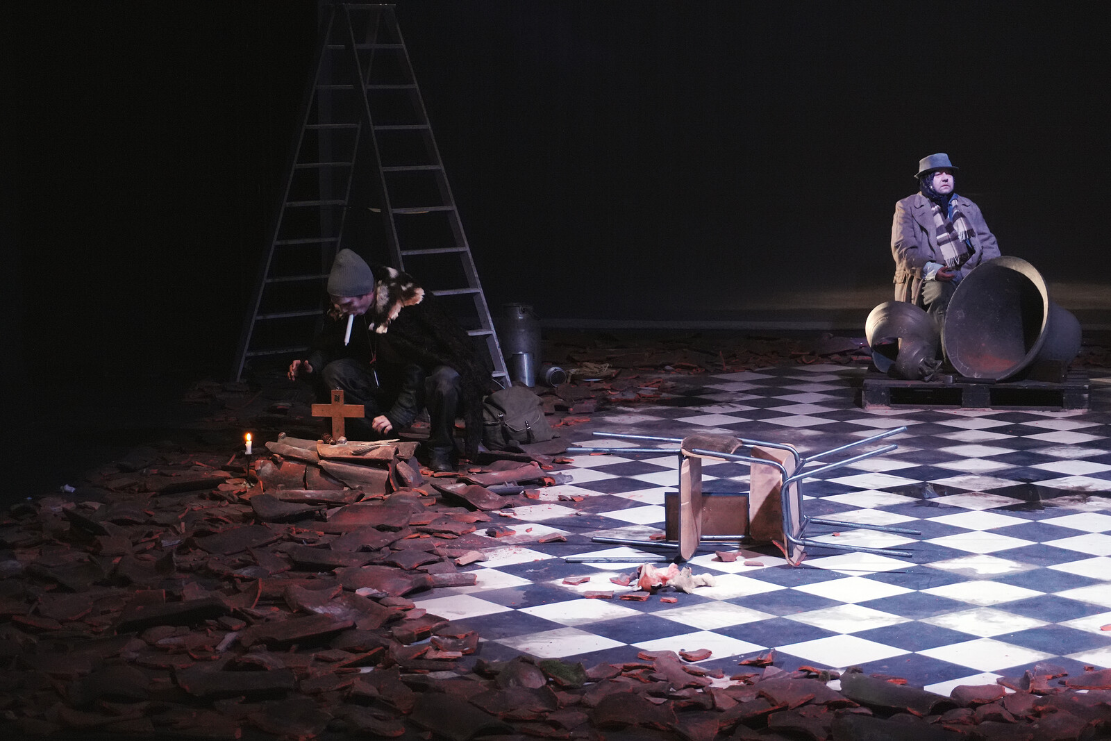 Rubble, roof tiles, a checkerboard floor, two actors, church bells