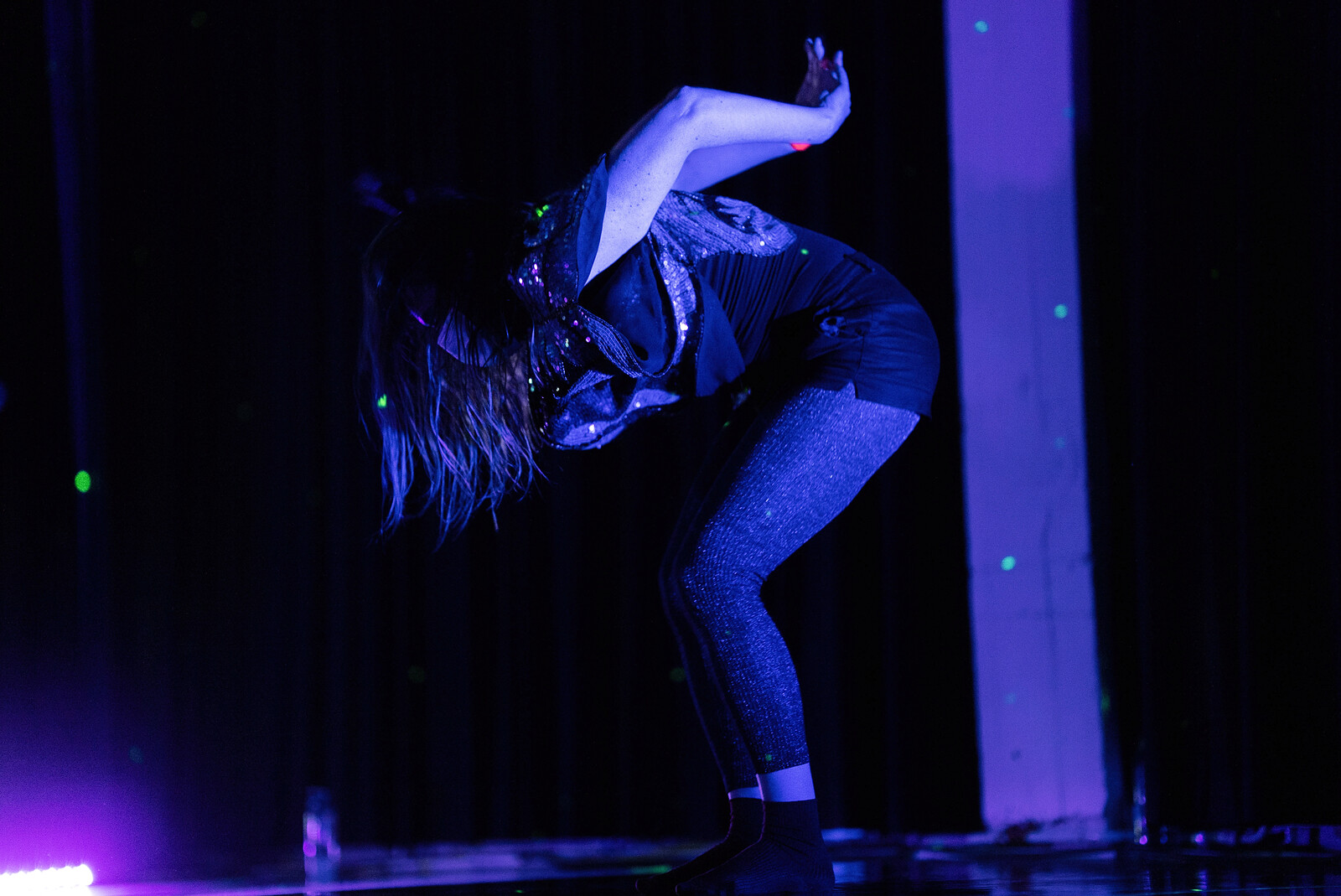 Gekrümmte Person in Schwarzlicht