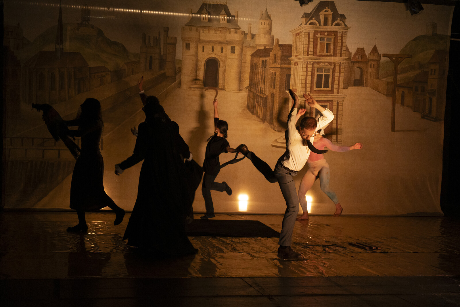 The performers dance wildly on stage.