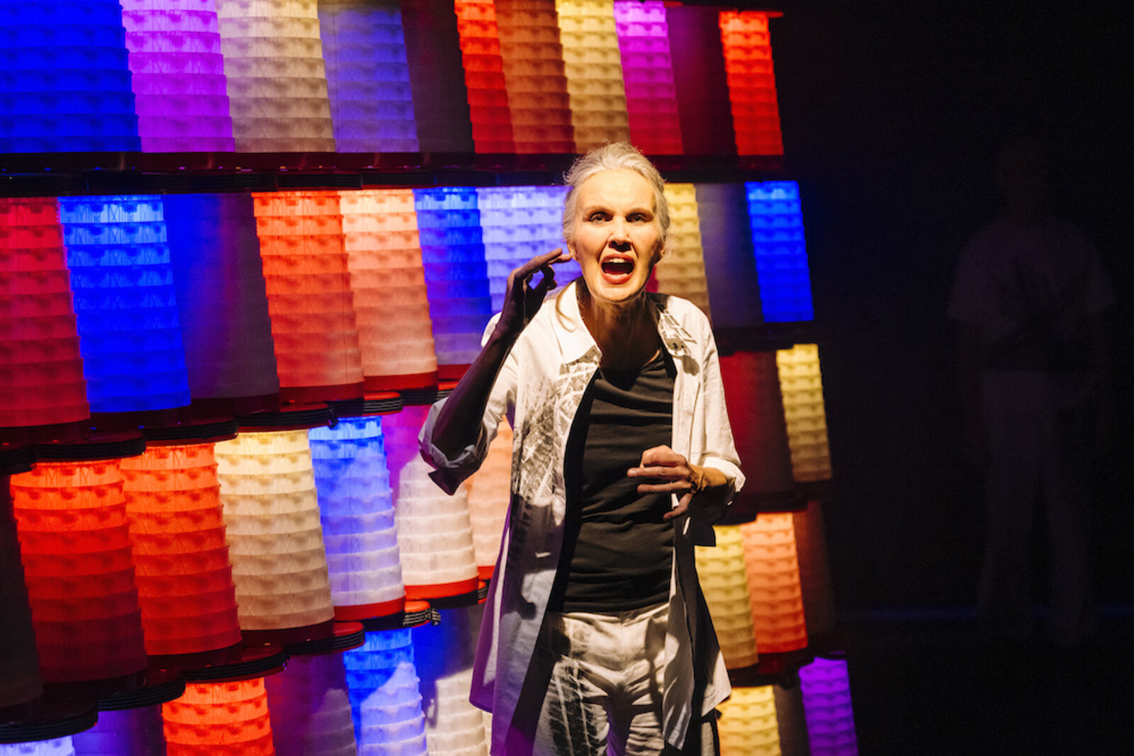 Actress in front of an illuminated wall