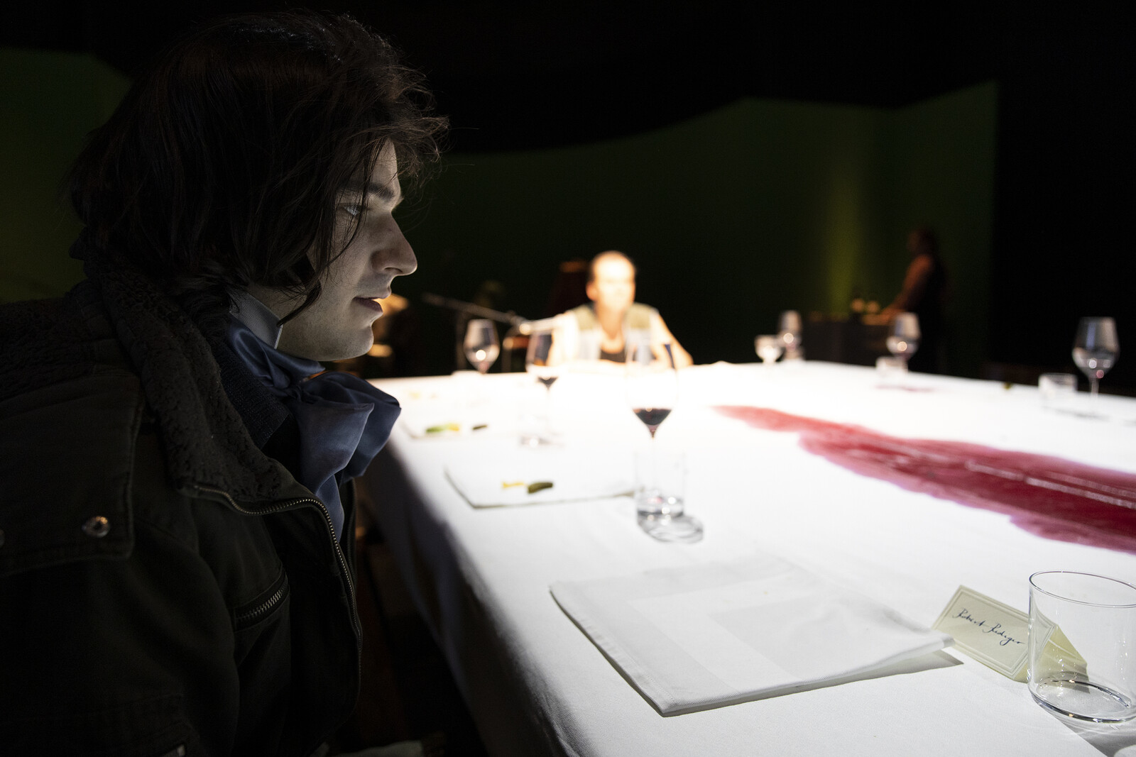 Player sits at long table