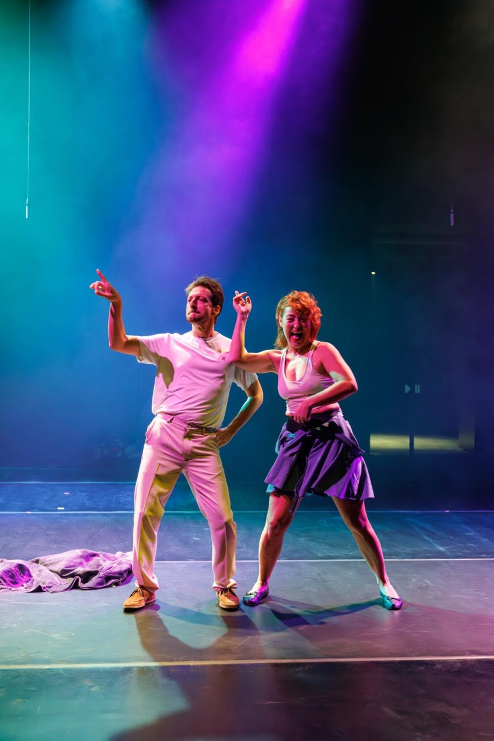 Two people are standing on stage